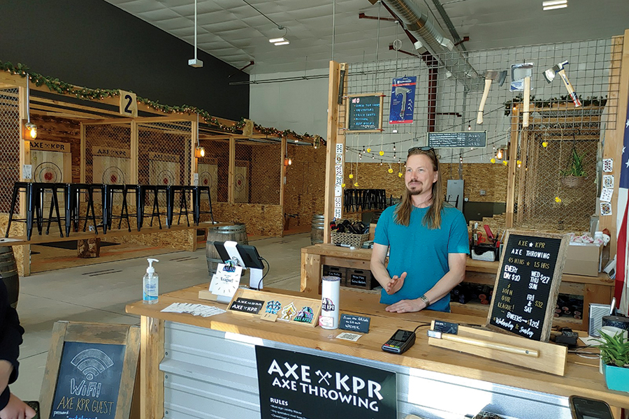 Landon Lawson and his wife, Valery, opened AXE KPR, an axe-throwing venue, in Pasco shortly before the Covid-19 pandemic. They survived the downturn and cater to leagues, groups and others interested in throwing axes, ninja stars and other items. (Photo by Wendy Culverwell)