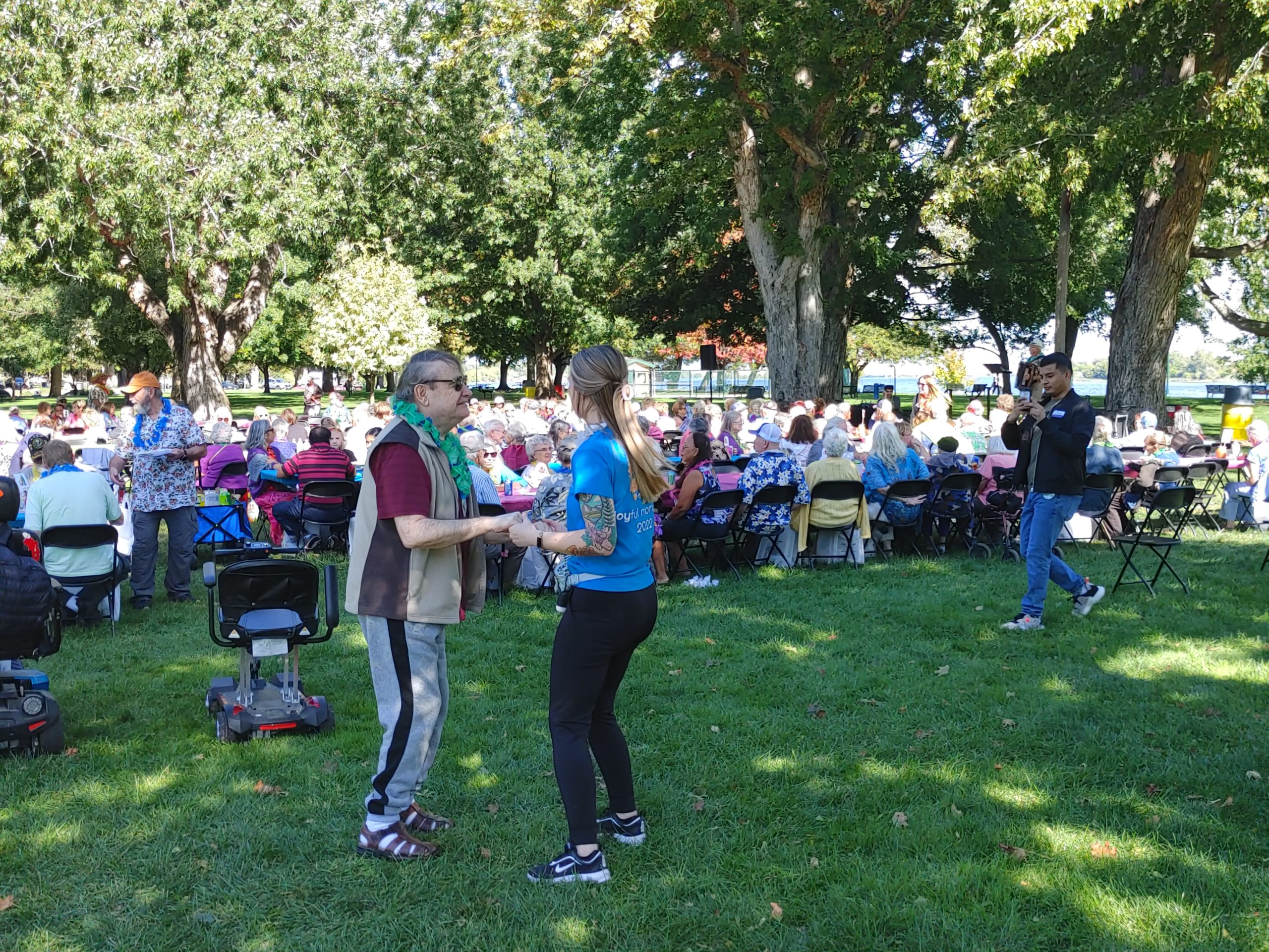 Lenny Ross, 73, of Richland, dances with Ciera Huie, a staff member at Kennewick’s Columbia Crossing of Grandridge, while an accordion player performed at the 2022 All Senior Picnic, held Sept. 29 at Howard Amon Park in Richland. (Photo by Wendy Culverwell)