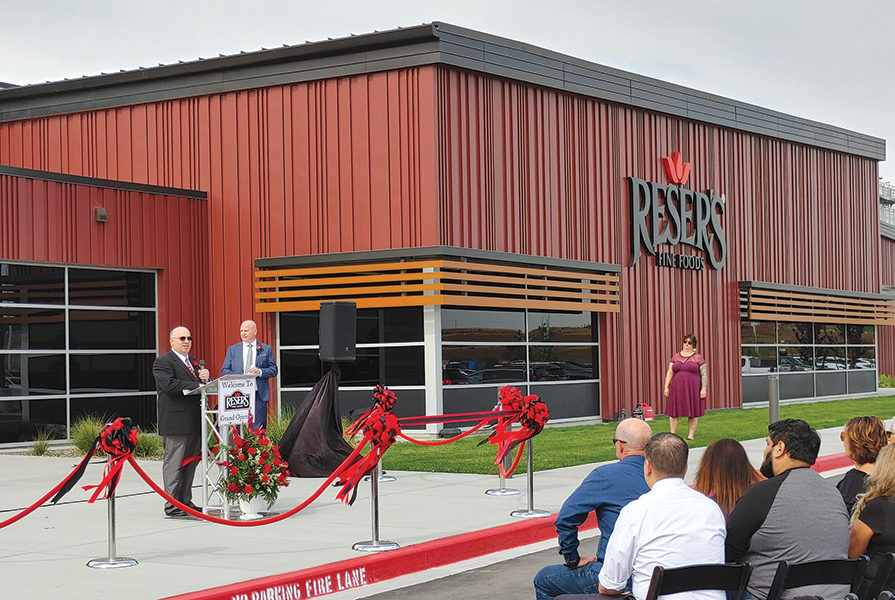 Rob Wiskerchen, left, general manager, Reser’s Pasco plant, and Gary McEvoy, vice president of hotfill operations, speak at a ribbon-cutting ceremony honoring the start of processing at its 250,000-square-foot plant in the Port of Pasco’s PIC395 industrial park. (Photo by Wendy Culverwell)