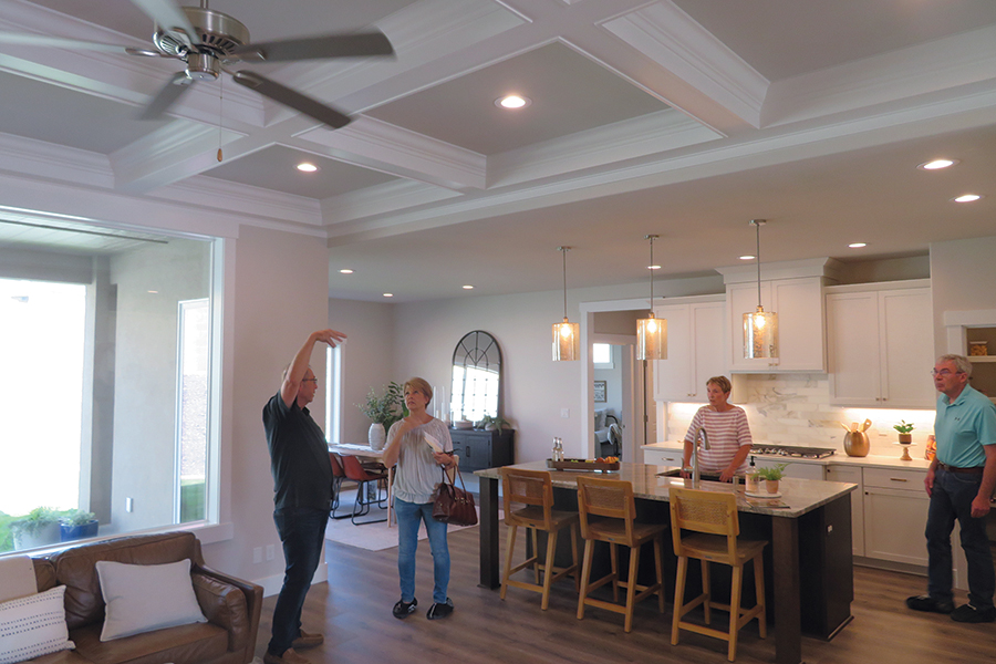 Brett Lott, left, of Brett Lott Homes talks with a Parade of Homes visitor about the step ceiling, which he said was his favorite feature of the home at 2479 Maggio Loop in Richland. (Photo by Kristina Lord)