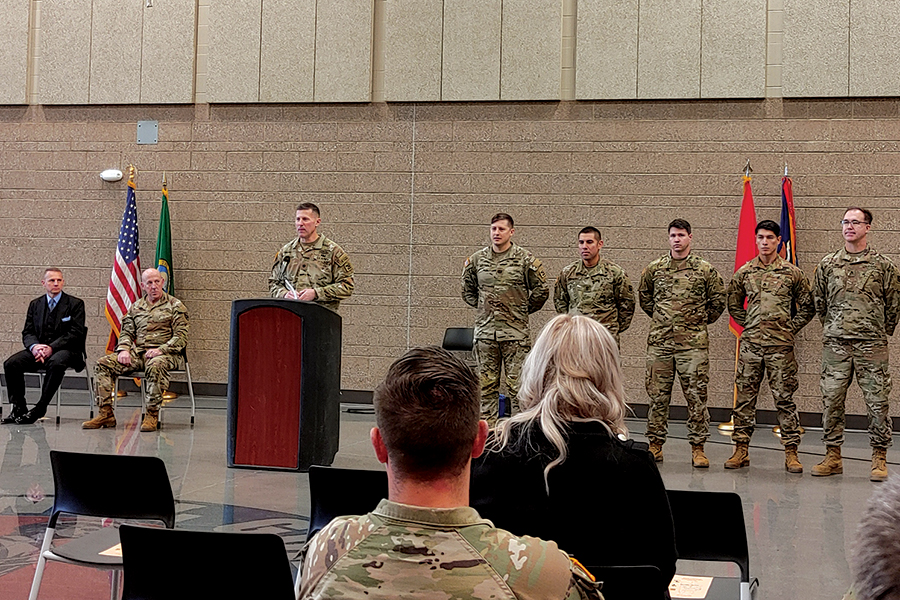 Lt. Col. William Cooper, commander, 1st Battalion, 161st Infantry Regiment, speaks during ribbon-cutting ceremonies at the Richland Readiness Center as soldiers responsible for overseeing it stand at parade rest on Dec. 7. (Photo by Wendy Culverwell)