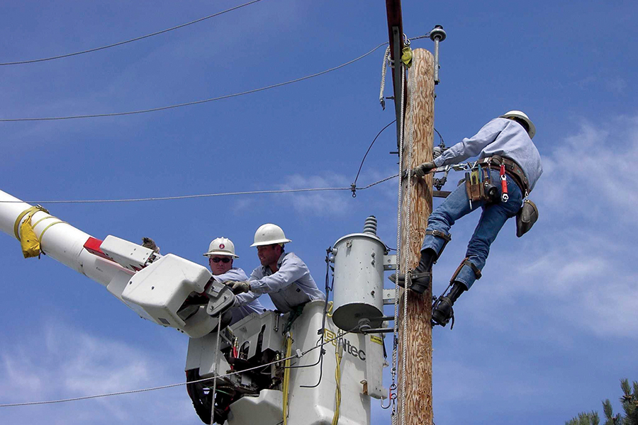 Three linemen work on a power pole in Franklin County. (Courtesy Franklin PUD)