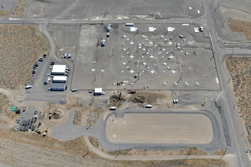 An aerial view of U Tank Farm on the Hanford site shows the completed evapotranspiration basin next to the tank farm. The basin will collect rainwater and snowmelt that runs off an interim surface barrier that Fowler General Construction will install this year. (Courtesy Office of Environmental Management)

