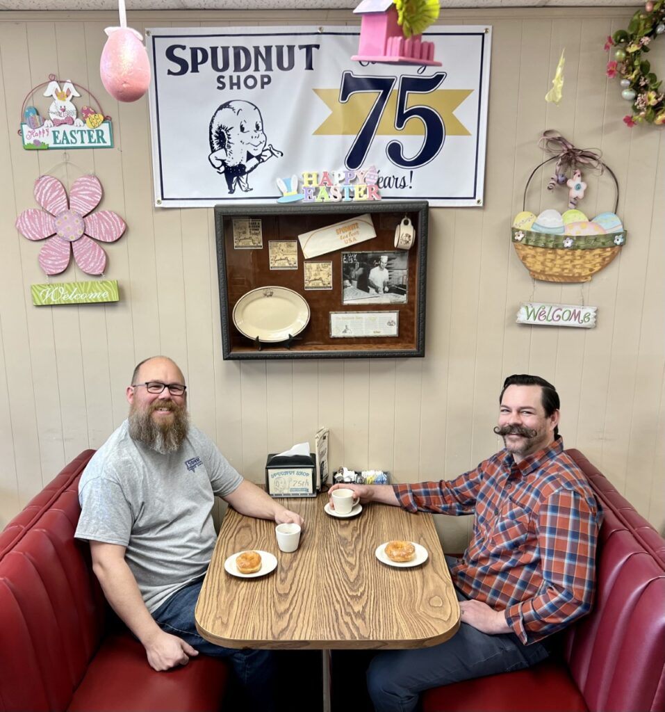 Mike Bishop, left, and Ryan Pierson are taking over the iconic Spudnut Shop in Richland’s Uptown Shopping Center. They pledge to maintain the charm and feeling of community that’s helped the shop thrive for 75 years. (Photo by Sara Schilling) 