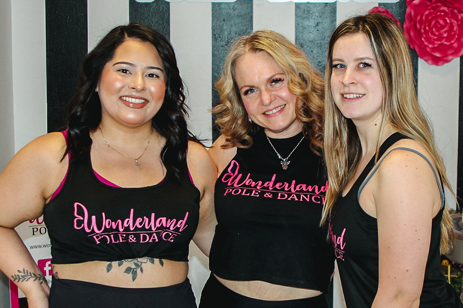 Wonderland Pole and Dance studio owner Lindsey Ross, center, poses with instructor Lianne Meyer, right and student Yoselin Pedraza at her studio at 1823 George Washington Way in Richland. Wonderland offers a shame-free environment for students to explore movement. (Photo by Jamie Council)