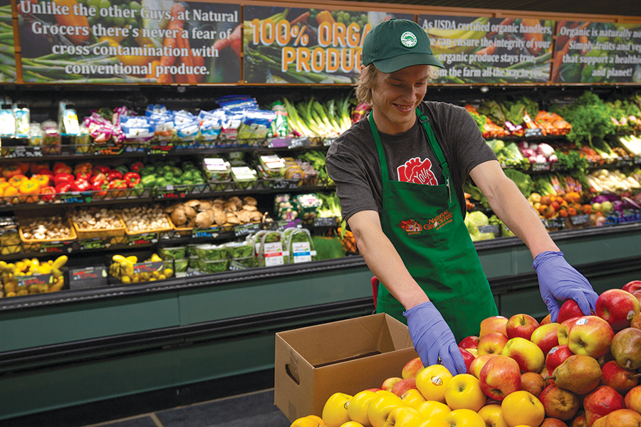 A produce manager stocks apples at a Natural Grocers store. The store at 
751 N. Columbia Center Blvd. in Kennewick opens Aug. 2. (Courtesy Natural Grocers)