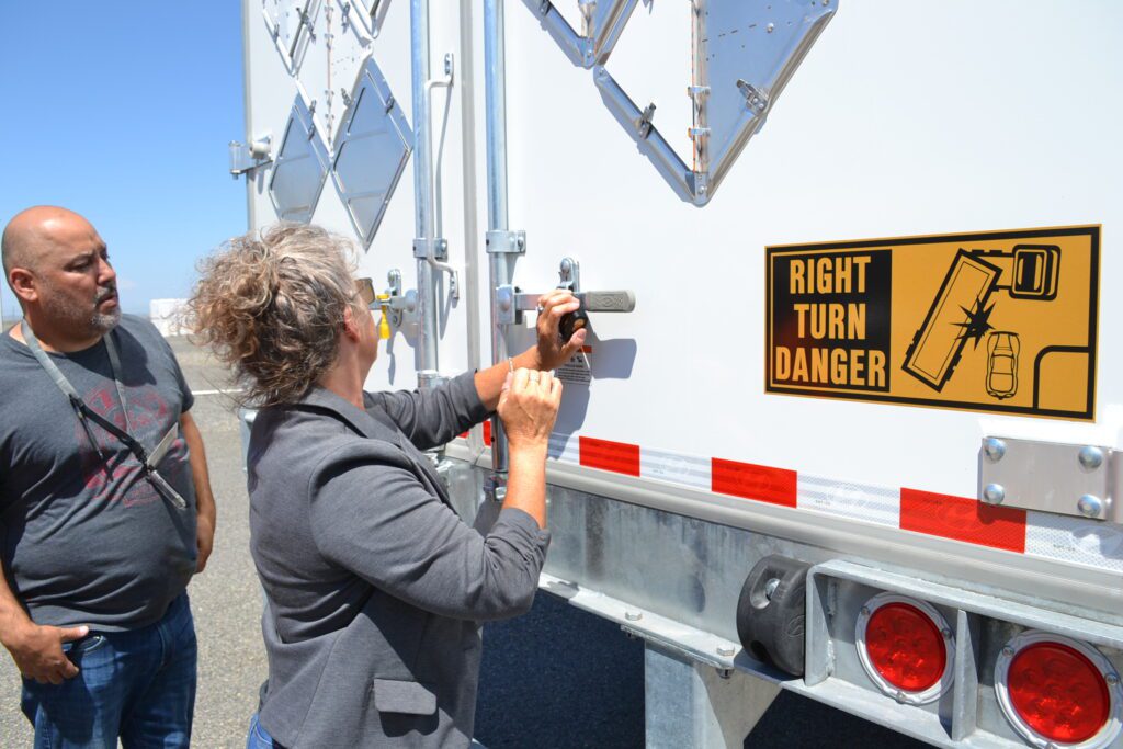 Hanford staffers Juan Guajardo, left, and Lezlie Arntz use a special lock on the truck holding classified records with the key only accessible by the U.S. National Archives upon arrival. (Courtesy HMIS) 
